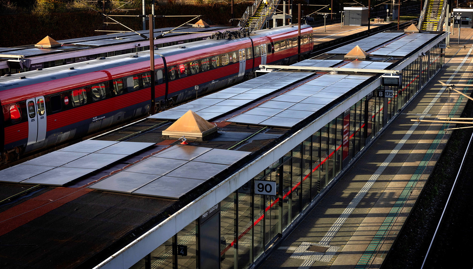 Image from the article showing PV panels on top of track shelters (I think)